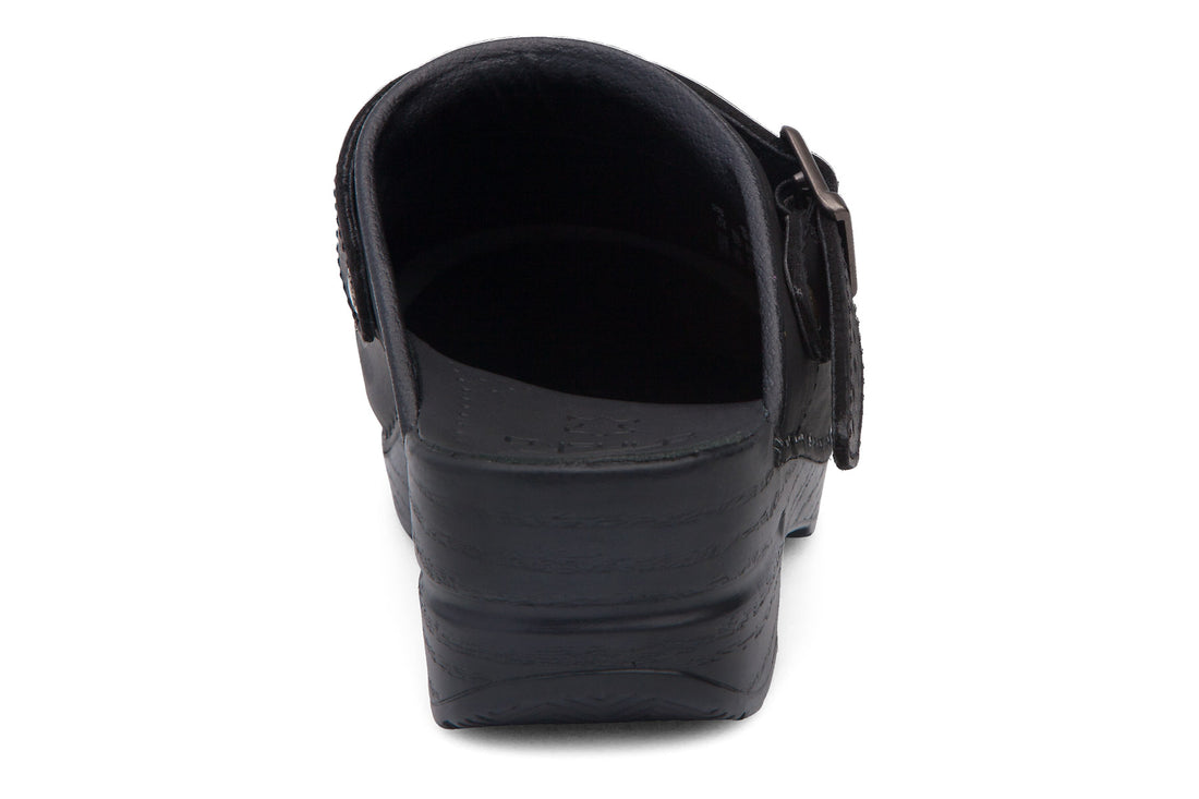 Clog, black leather, Dansko Ingrid sling-back with strap, highlighted stitching on sole, comfort support visible.