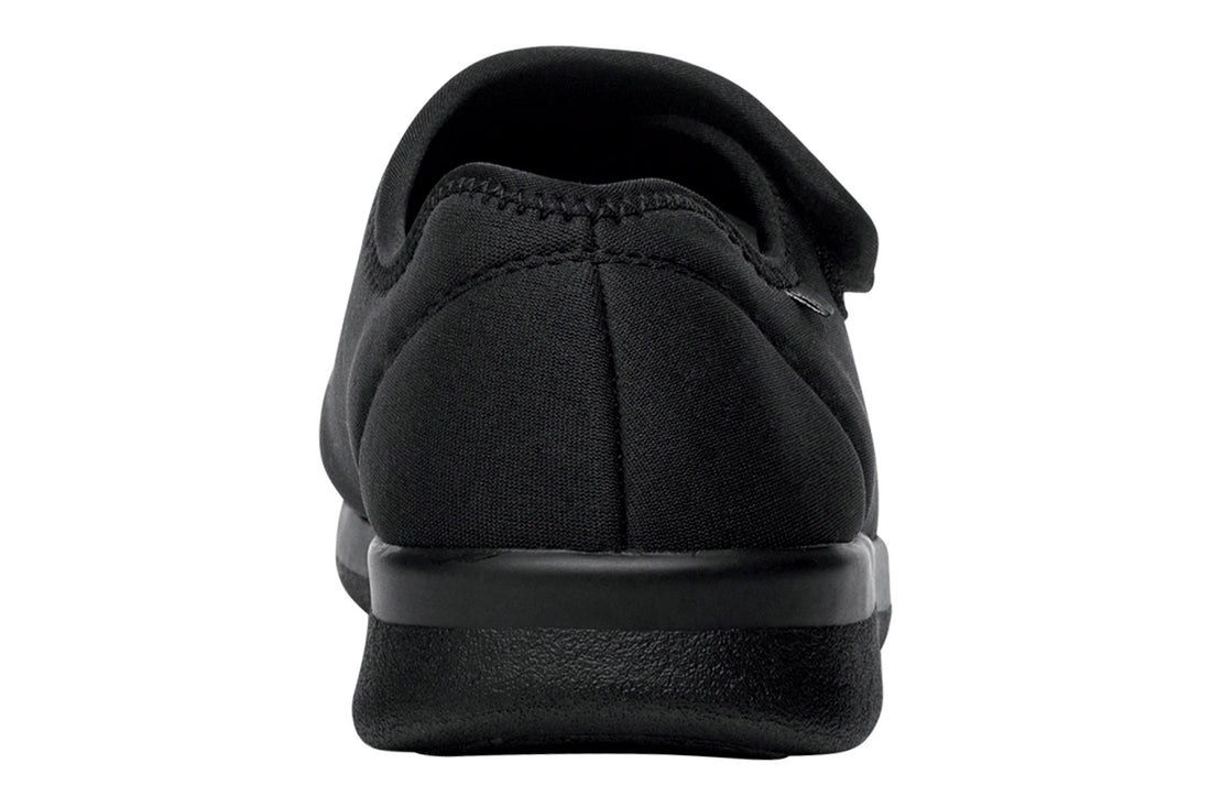 Shoe with black chevron rubber sole, Propet logo, for Cush N Foot slippers; features removable insoles for comfort.